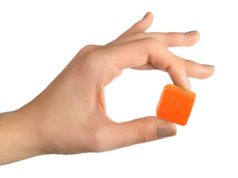 Hand holding CBD gummy