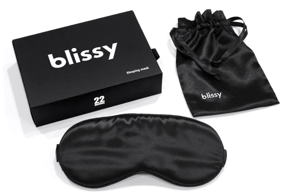 A black sleep mask at the box it comes in form Blissy