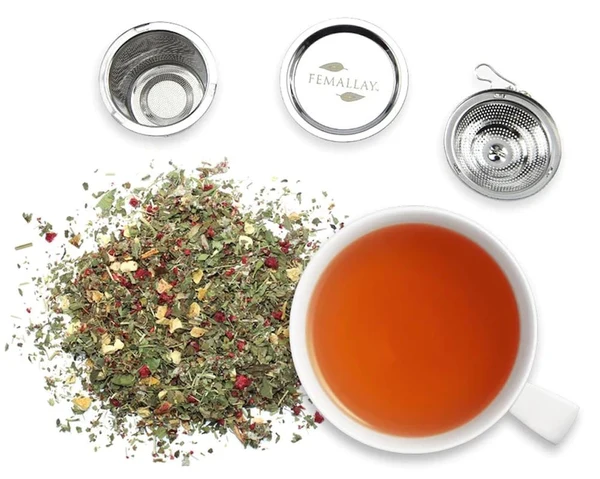 Femallay organic loose tea leaves next to newly brewed tea in a mug
