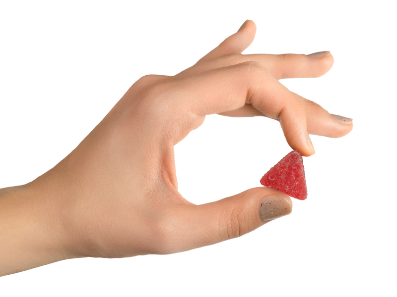 Hand holding CBD gummy
