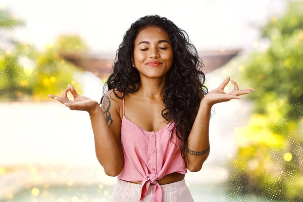 A woman engaging in a relaxation technique as a tip to manage Hangxiety