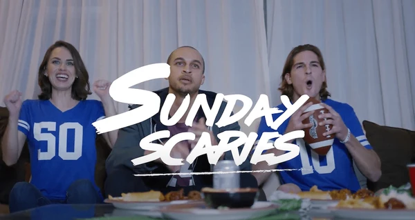 A group of friends sit down on a couch together watching Monday Night Football behind the logo from Sunday Scaries