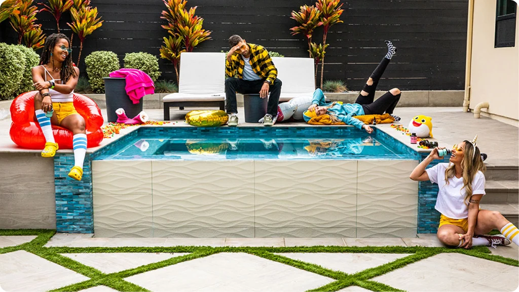 A group of friends with the Sunday Scaries lounging by a hot tub, hungover after a weekend of partying