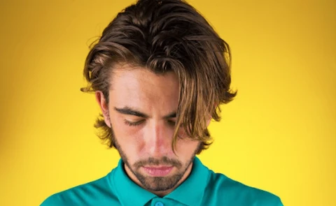 A man looks down because he is depressed