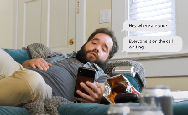 Man is late for a work Zoom call and his co-workers are asking him where he is on chat