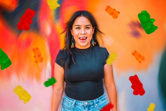 A female Sunday Scaries influencer with gummy bears flowing around her showing if CBD makes you high or not