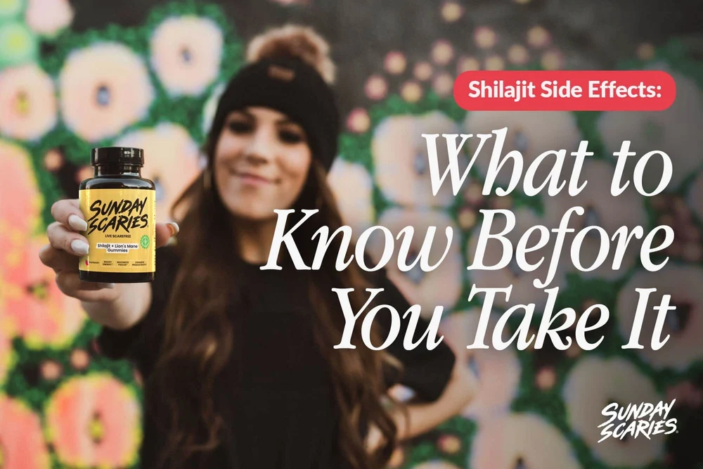 A woman with a beanie on in front of a graffiti wall holds up Sunday Scaries Shilajit gummies. 