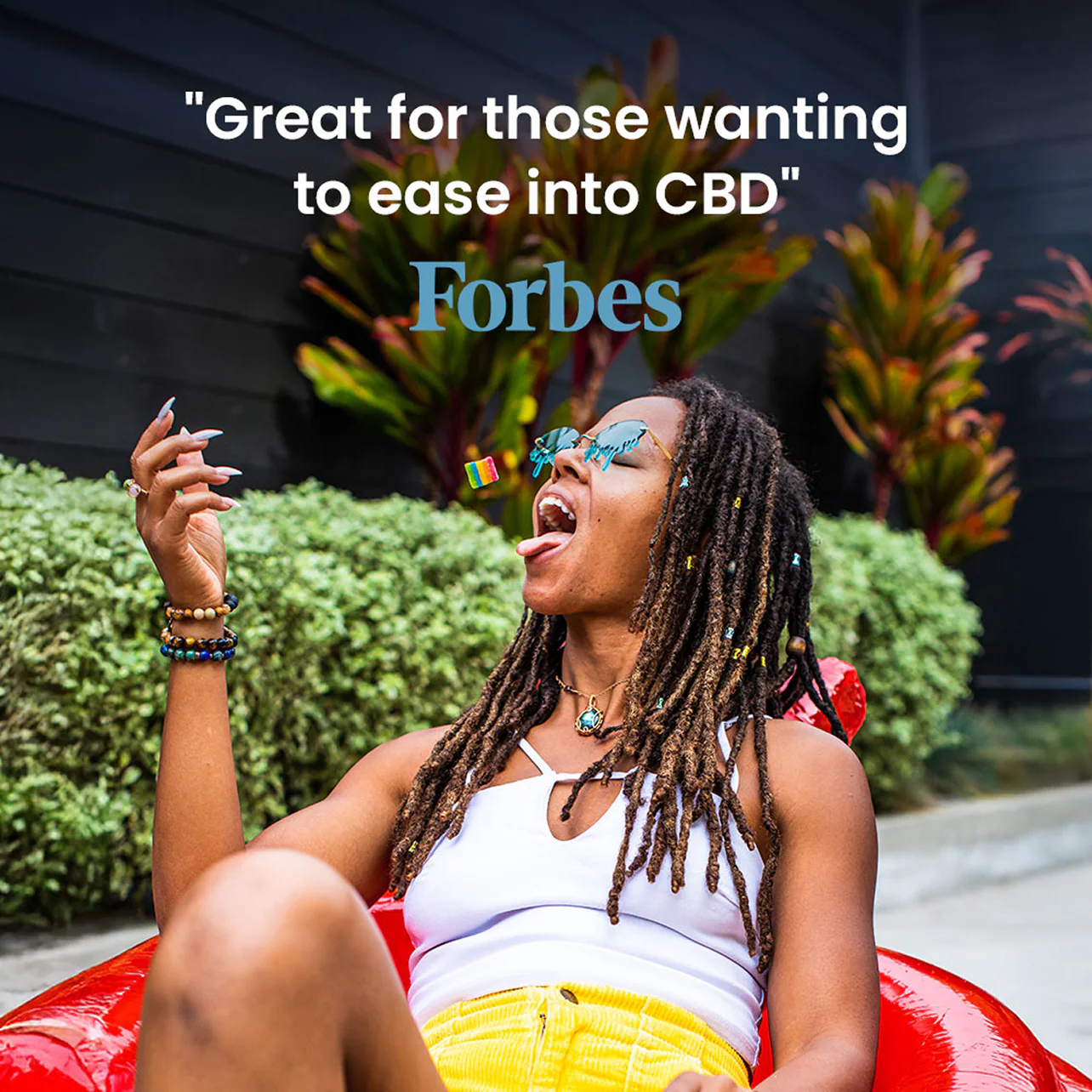 Person relaxing in a red chair with a quote from Forbes that reads 