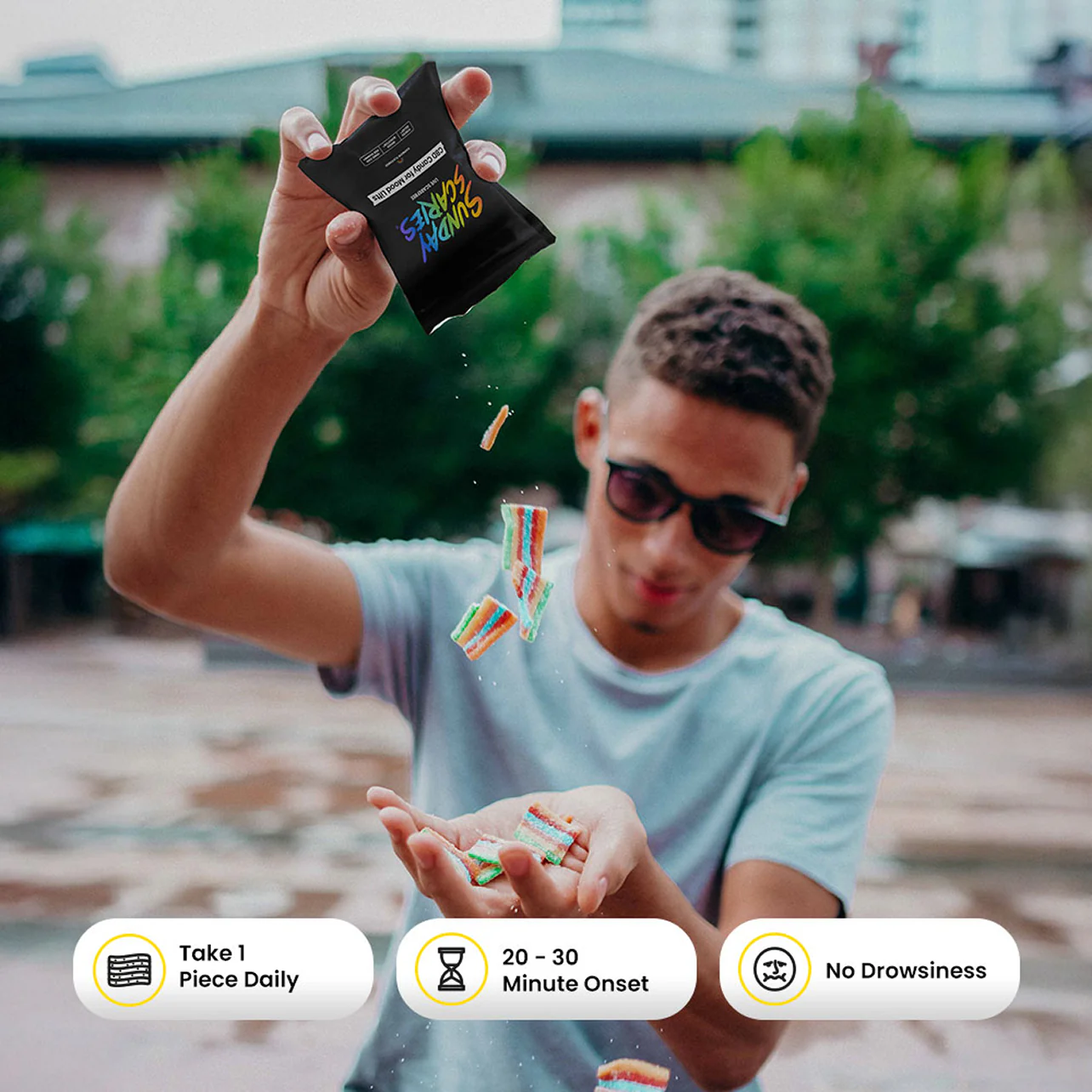 Person outdoors holding a CBD candy pouch and colorful candies pour out with product call out icons.