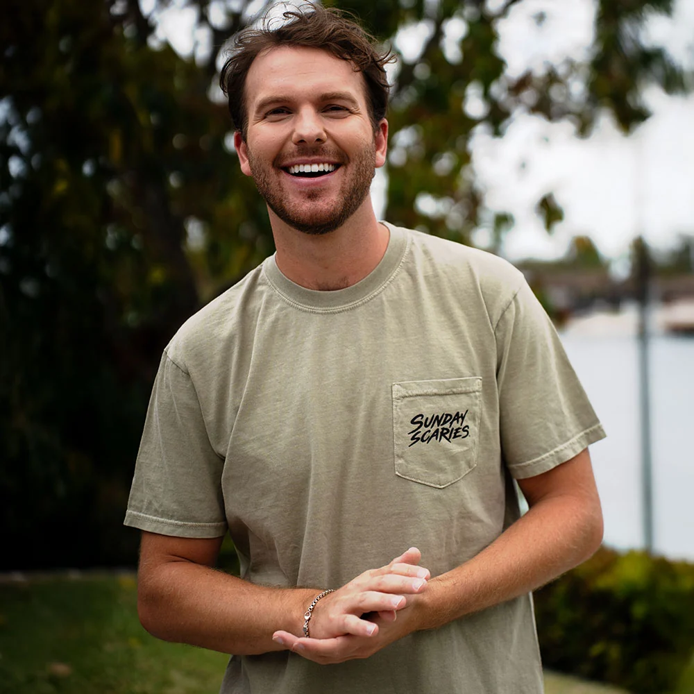 A male model rocks the Sunday Scaries pocket tee outside